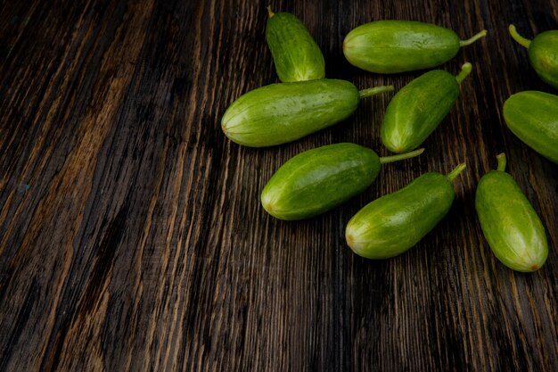 Side view of cucumbers on wooden surface with copy space