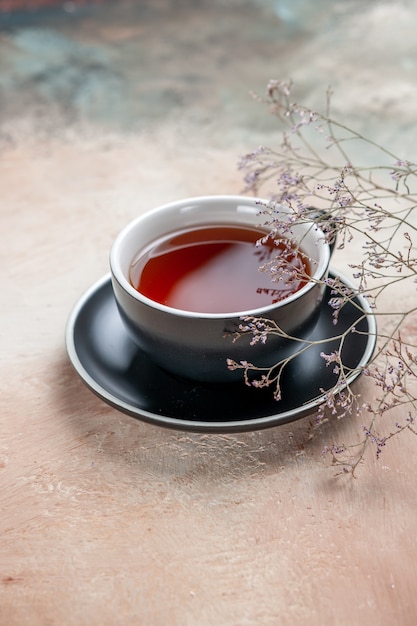 Side view a cup of tea a cup of tea next to the tree branches