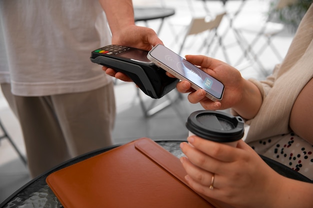 Side view customer paying with nfc device