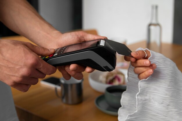 Side view customer paying with nfc device