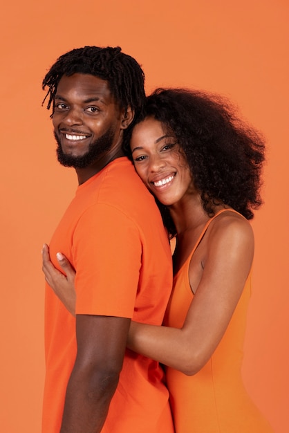 Side view cute couple posing together in studio