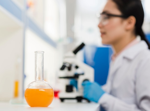 Side view of defocused female scientist with lab substance