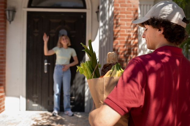 Side view delivery man with groceries