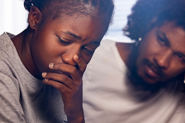 Free photo side view depressed woman at home