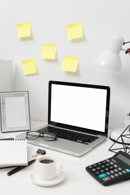 Side view desk arrangement with post its on the wall