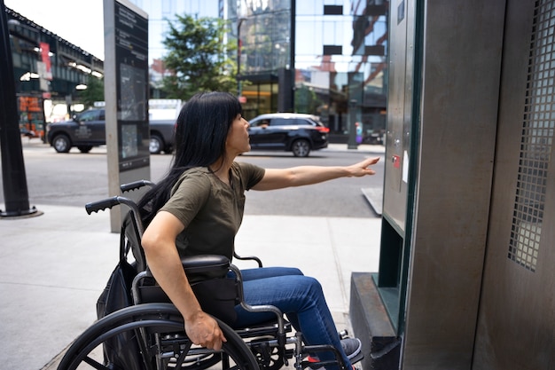 Free photo side view disabled woman by the elevator