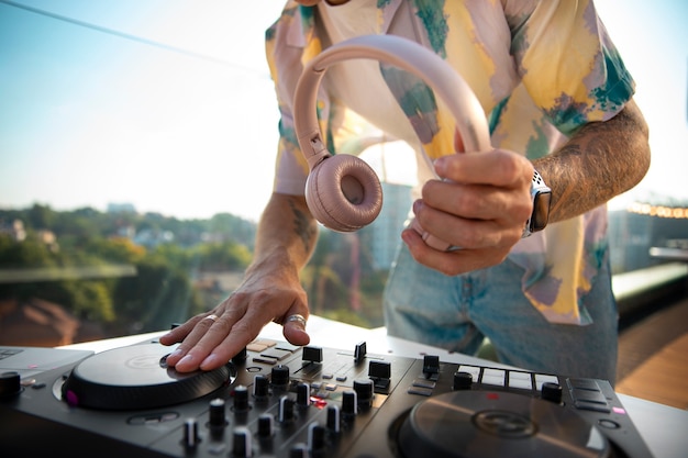 Side view dj holding headphones