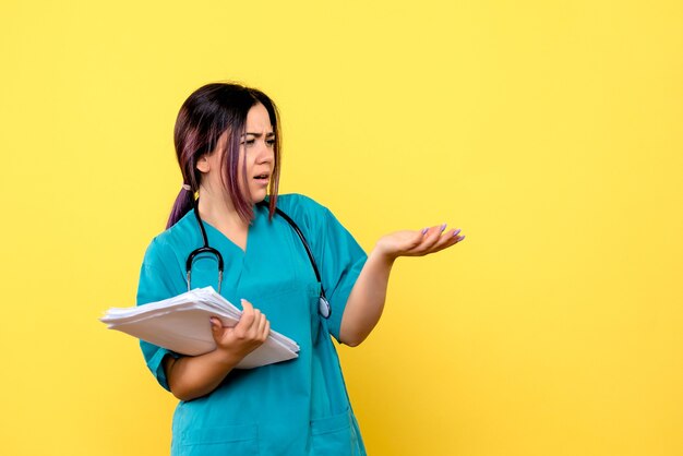 Side view of a doctor asks colleagues how to cure the patient with covid