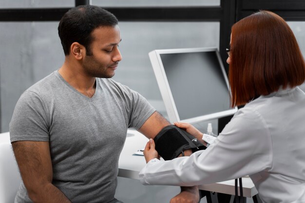 Side view doctor checking patient