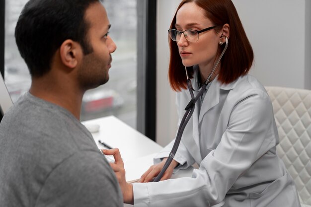 Side view doctor checking patient