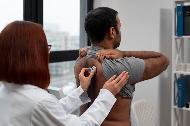 Side view doctor checking patient