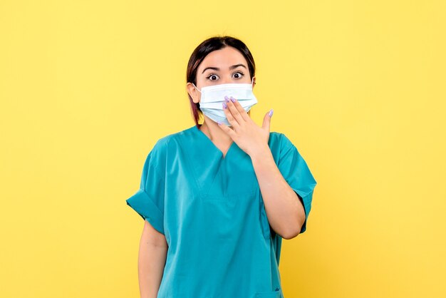 Side view of the doctor encourages people to wear masks during a pandemic