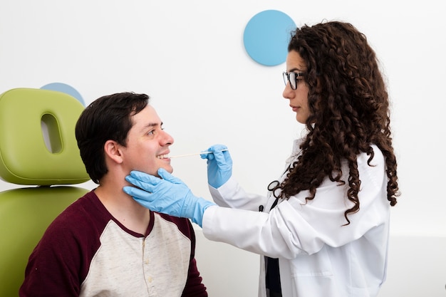 Side view doctor examining smiley patient