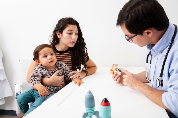 Side view doctor explaining to a mother