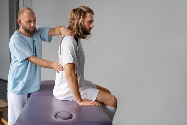 Side view doctor helping patient