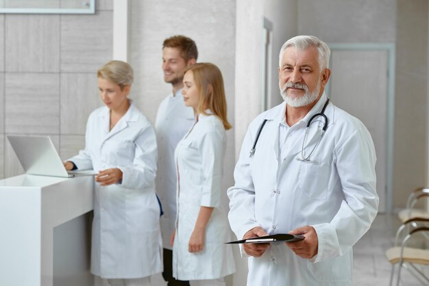 Side view of doctor and his coleagues in clinic