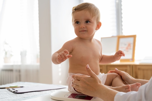 Side view doctor holding baby