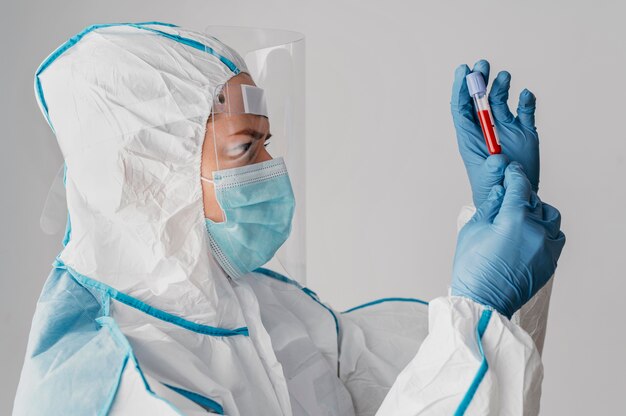 Side view doctor holding a blood sample