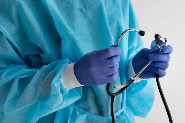 Side view doctor holding stethoscope