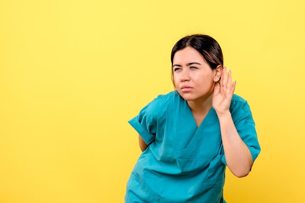 Side view of a doctor listens to complaints of patient with serious illness