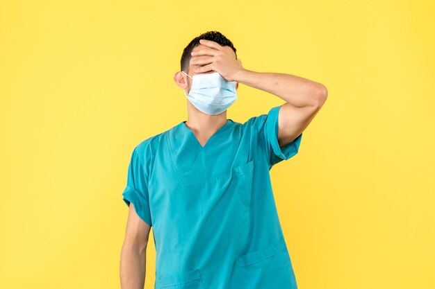 Side view of a doctor in mask has a headache