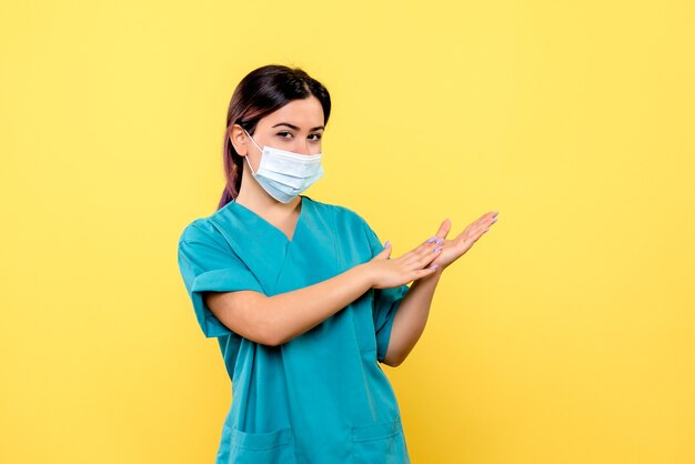 Side view of a doctor in mask talks about hand washing