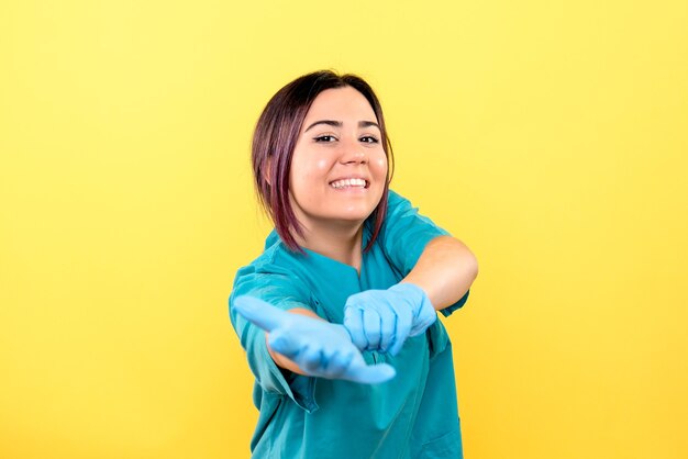 Side view of a doctor in the medical gloves is talking about coronavirus pandemic