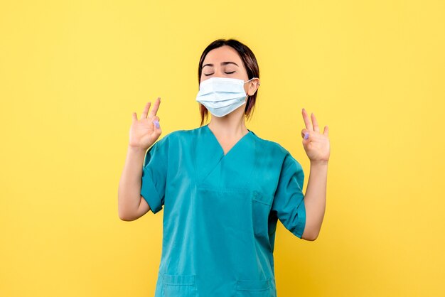 Side view of the doctor in the medical mask knows about how to cure patients