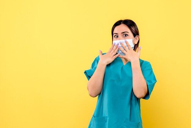 Side view of a doctor in medical uniform is surprised