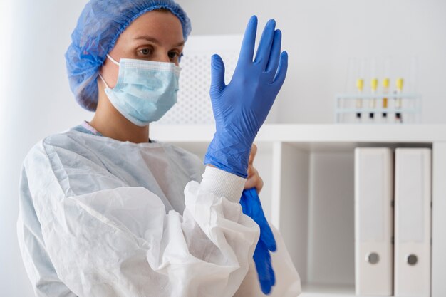 Side view doctor putting on glove