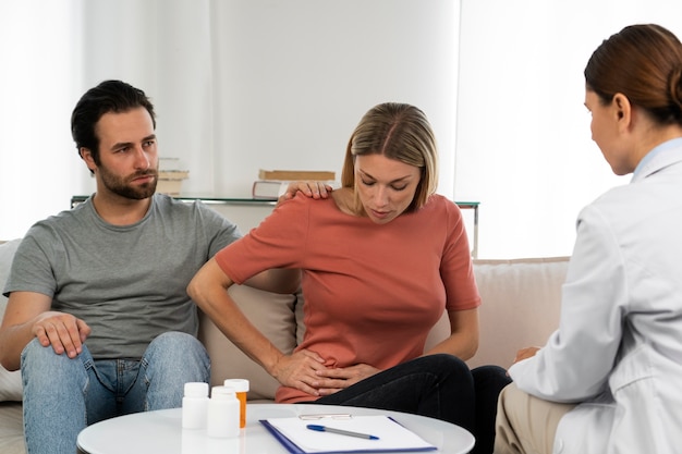 Side view doctor talking to patients