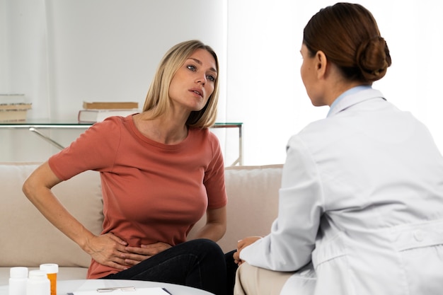 Side view doctor talking to woman