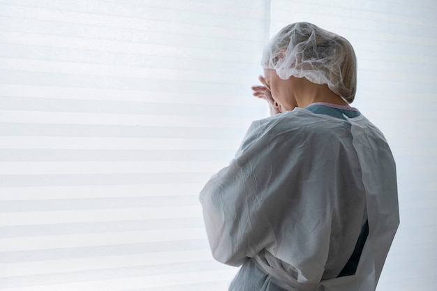 Side view doctor wearing medical gown