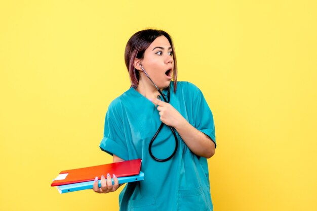 Side view of the doctor with phonendoscope documents is surprised