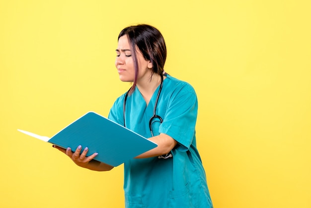 Side view of the doctor writes prescription for a patient