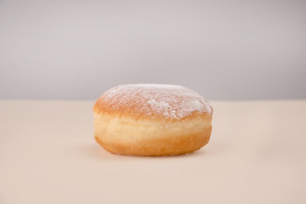 Side view of donut with powder