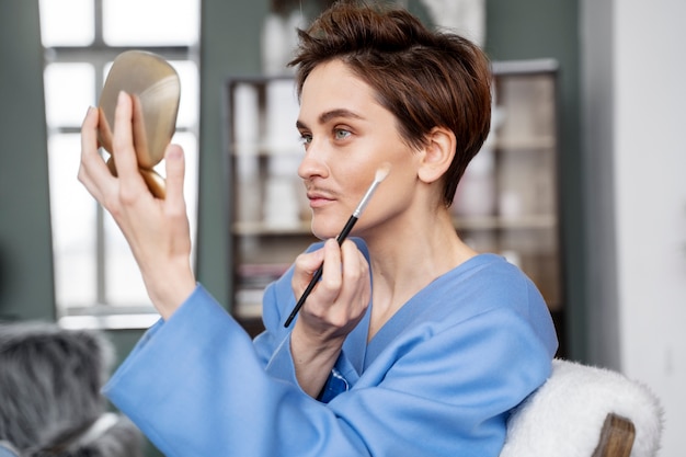 Side view drag king putting on makeup