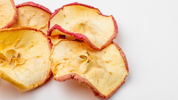 Side view of dried apple slices on white background