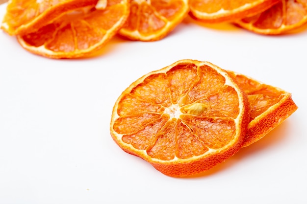 Side view of dried orange slices isolated on white background