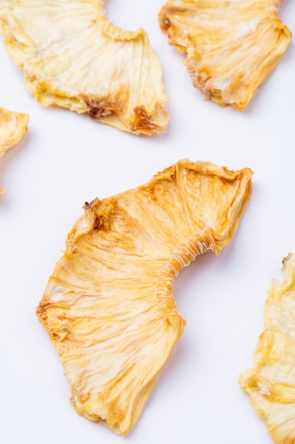 Side view of dried pineapple slices isolated on white background