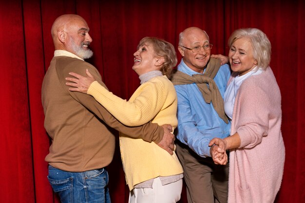 Side view elder friends dancing together