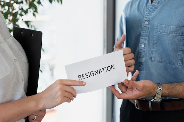 Free photo side view employee holding resignation letter