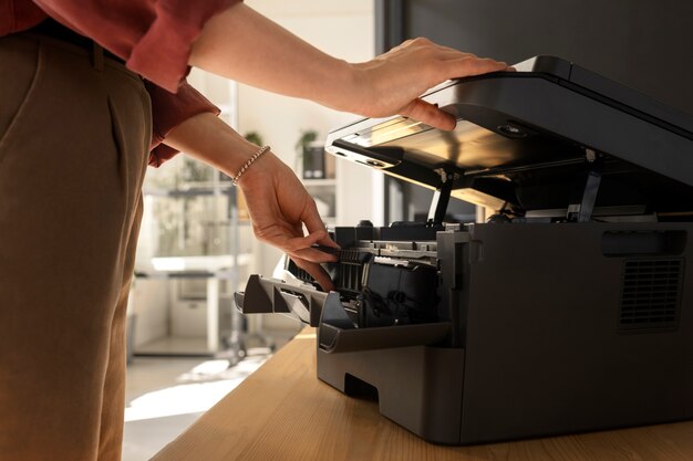 Side view employee using printer