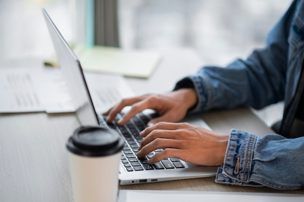 Side view employee working on laptop