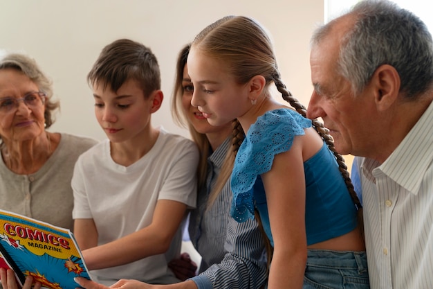 Free photo side view family reading comics together