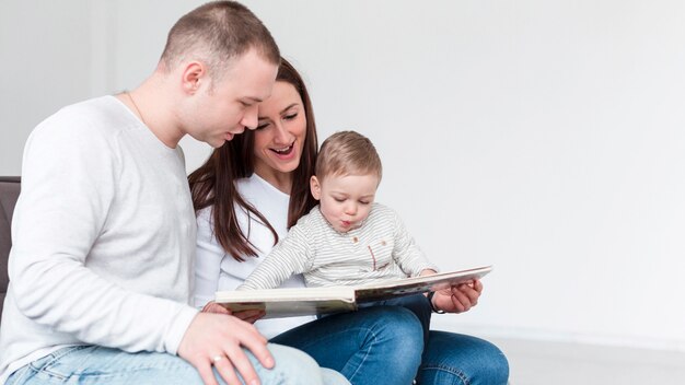 Side view of family with child and book