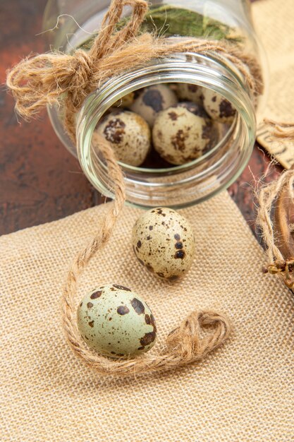 Side view of farm fresh eggs in fallen glass on a brown background