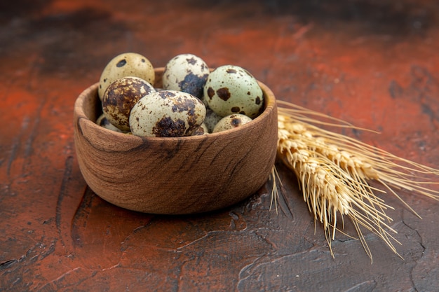 Side view of farm fresh eggs in a wooden pot on a brown background