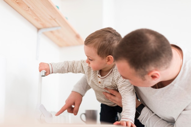 Side view of father and child in the kitchen