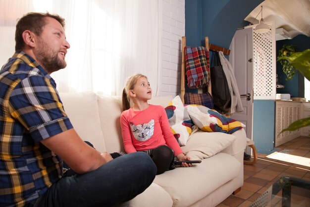 Side view of father and daughter looking up